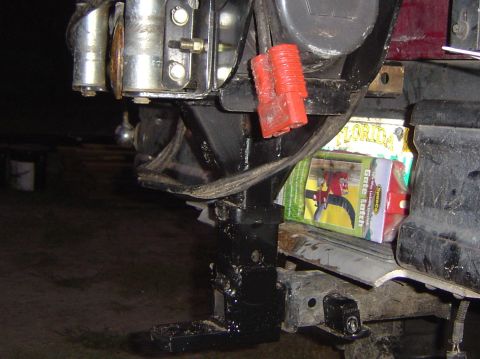 1993 Ford Bronco - Close-up of a brush guard with a winch and red electrical connectors, with packaging visible behind it.