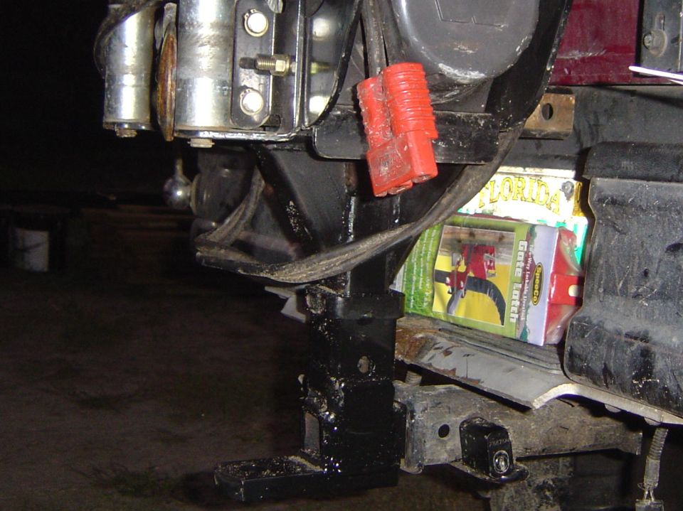 Brush guard with winch and red connectors, some packaging visible