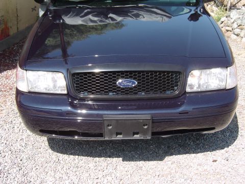 1999 Ford Crown Victoria - The honeycomb grille and headlight design indicate a 2003 or later model year Ford Crown Victoria.