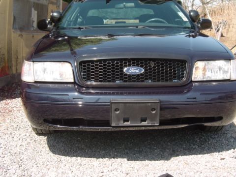 1999 Ford Crown Victoria - Front view of a Ford Crown Victoria, showing the grille and headlights.