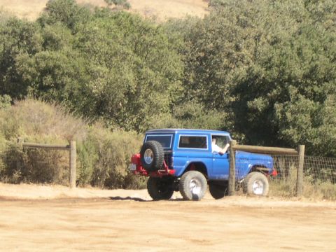1990 Ford Bronco - A blue 1978 Ford Bronco is seen parked near a wooden fence in a rural setting.