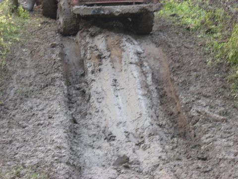 1983 Ford Bronco - Two vehicles navigating a difficult muddy trail, with one vehicle's rear end prominently featured.