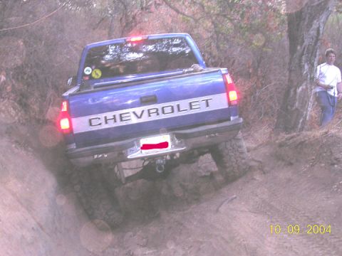 1994 Ford Bronco - This Chevrolet pickup truck is navigating a challenging off-road trail.