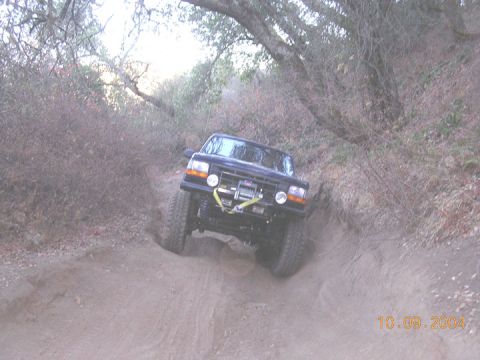 1994 Ford Bronco - This vehicle navigates a challenging off-road trail, its capabilities on rough terrain.