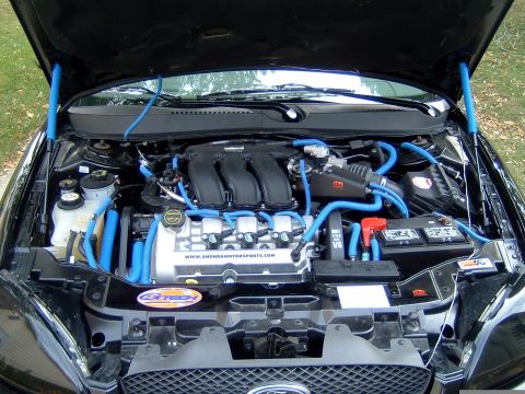 2004 Ford Taurus - Customized engine bay with bright blue hoses and accents.