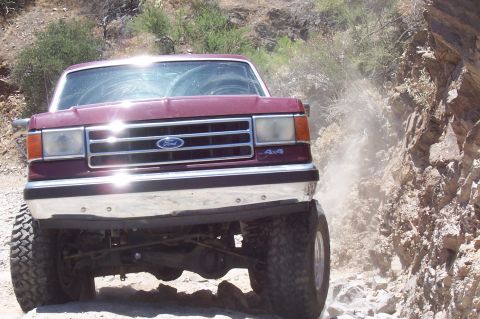 1992 Ford Bronco - This Ford Bronco is kicking up dust as it navigates a rough, off-road trail.