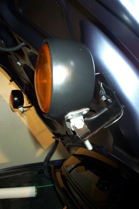 1998 Ford Crown Victoria - Close-up of an amber light assembly mounted inside a vehicle's trunk area.