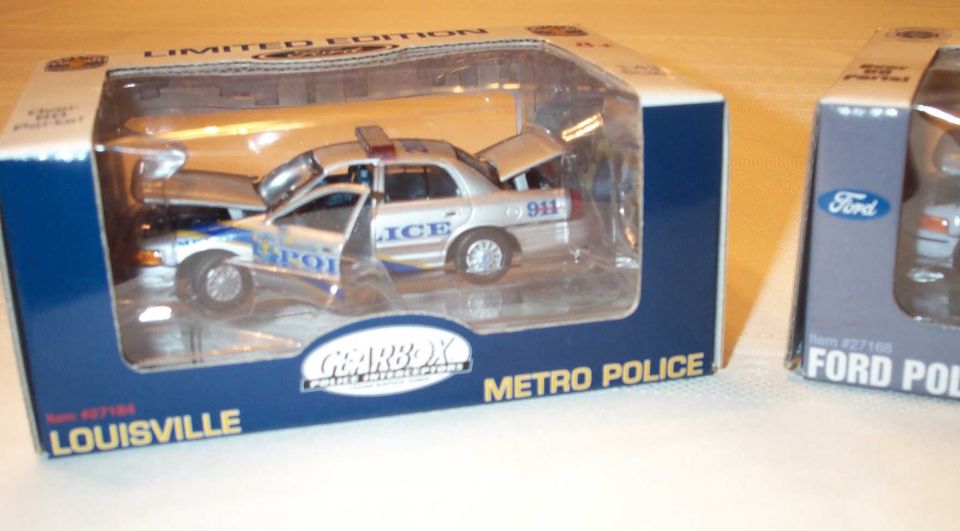 Boxed Gearbox Louisville Metro Police die-cast police sedan model, silver/white with 911 markings.