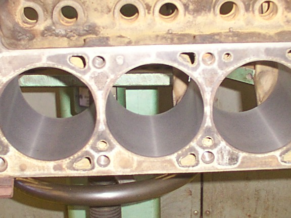 Close-up of engine block cylinders, showing wear and casting marks