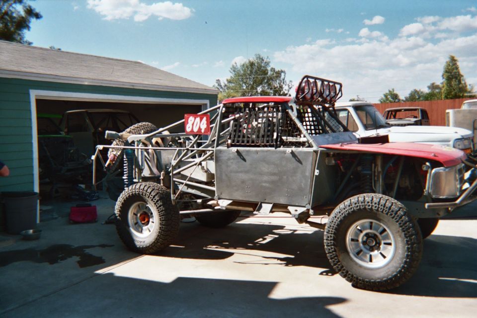 Tube-chassis off-road race truck numbered 804 in a driveway