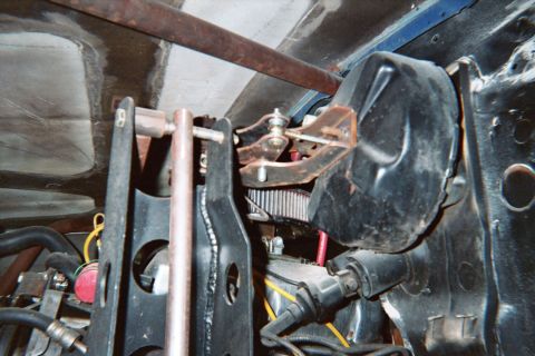 1990 Ford Bronco - Engine bay detail showing a red-topped air filter, brake master cylinder, and wiring inside a vehicle.