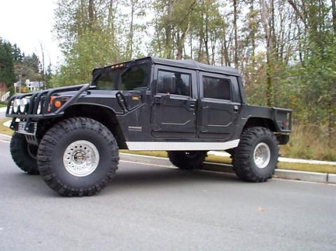 1982 Ford Bronco - This Hummer H1 four-door pickup truck features prominent off-road tires and a exterior.
