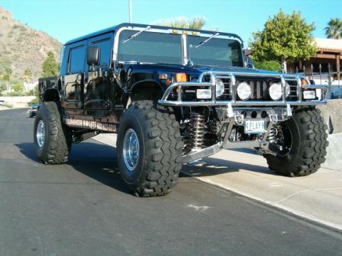 1982 Ford Bronco - This stretched Hummer H1 limo features massive off-road tires and a prominent chrome grille guard.