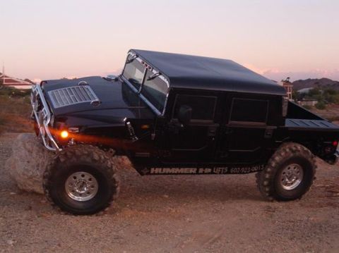 1982 Ford Bronco - This Hummer H1 is equipped with aftermarket lifts and large off-road tires.