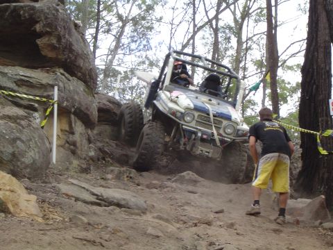 1982 Ford Bronco - Off-road vehicle navigates challenging rocky terrain during an event.