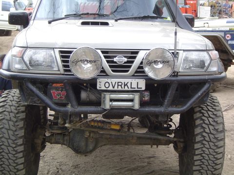 1982 Ford Bronco - Front view of a Nissan Patrol equipped with a winch and auxiliary lights, modified for off-road use.