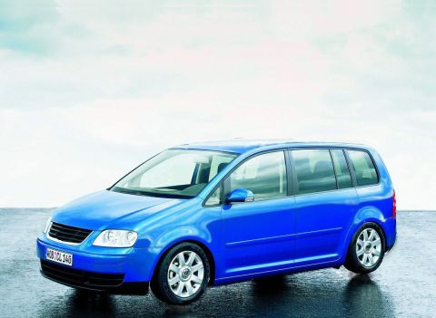 1998 Ford Taurus - A blue Volkswagen Touran is shown from a three-quarter front view against a bright, overcast sky.