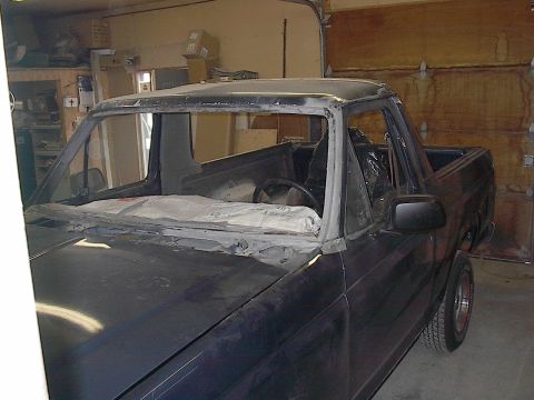 1986 Ford Bronco - Here's the Bronco halfway through sandblasting the pillar tops and all round the windshield.