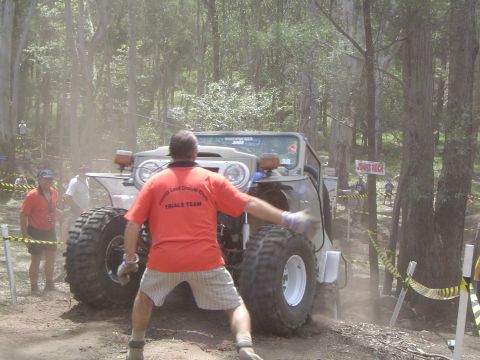 1982 Ford Bronco - A modified off-road vehicle tackles a challenging course during an event.