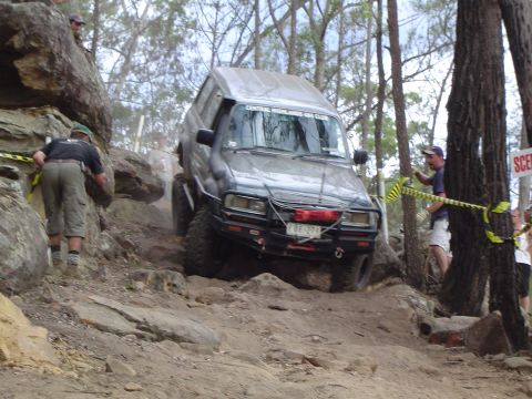 1982 Ford Bronco - This off-road SUV navigates a challenging rocky incline during an event.