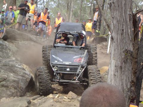1982 Ford Bronco - An extreme off-road vehicle tackles a challenging rock climb during an event.