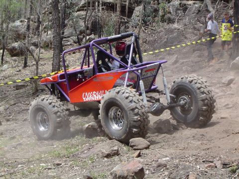 1982 Ford Bronco - Custom off-road buggy navigates a challenging rocky course during an event.