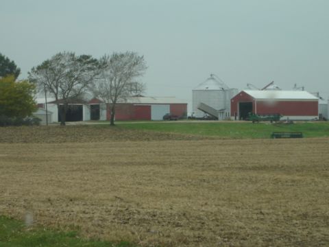 1992 Ford Bronco - A rural farm scene features a red barn, grain silos, and various vehicles parked on the grounds.