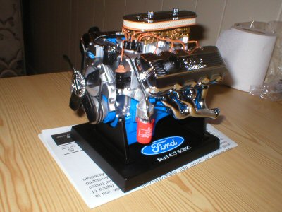 1987 Ford Crown Victoria LTD - A detailed model of a Ford 427 SOHC engine is displayed on a stand.