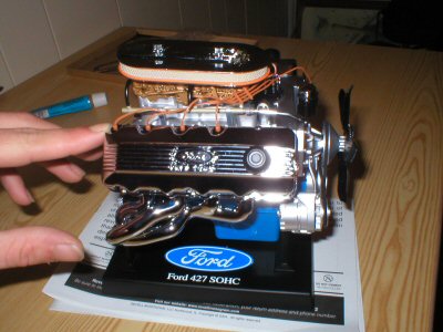 1987 Ford Crown Victoria LTD - A detailed model of a Ford 427 SOHC engine is shown on a black display stand.