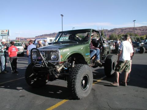 1988 Ford Bronco - Modified green SUV with large tires and off-road bumper. Album claims 1988 Ford Bronco, but this is likely an earlier model.