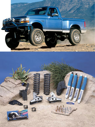 1993 Ford Bronco - Lifted 1993 Ford Bronco in action, with suspension components laid out.