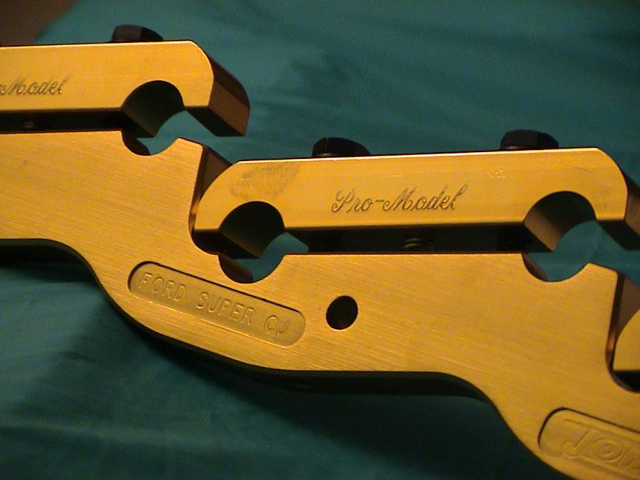 Gold engine part with "Pro-Model" and "FORD SUPER CJ" engravings