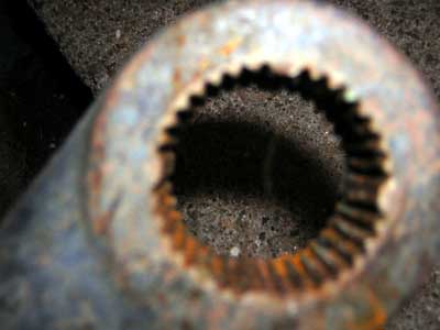 1995 Ford Bronco - A close-up view of a rusty, splined metal component.
