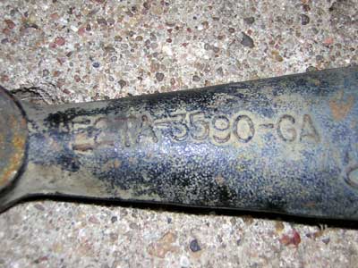 1995 Ford Bronco - Close-up of a metal part showing the stamped identification number E2TA-3590-GA.