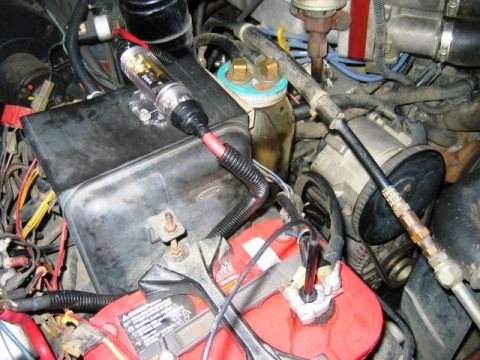 1985 Ford Bronco - Engine bay components including battery and inline fuse holder. The text '200A' is visible on the fuse holder.