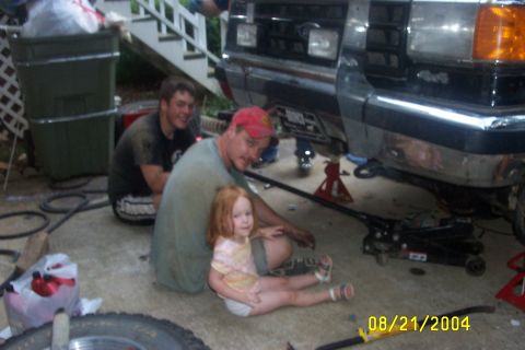 1979 Ford F-150 - Family working on a 1979 Ford F-150 truck in the driveway.