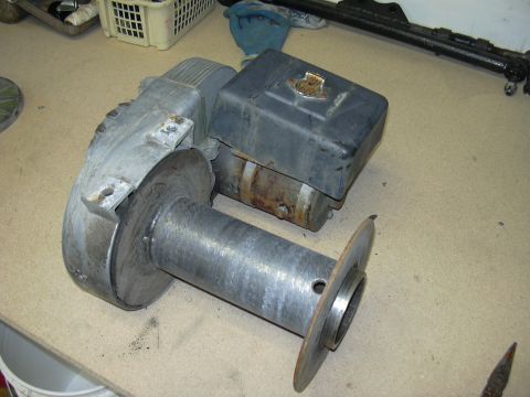 1991 Ford Bronco - A winch motor assembly is shown on a workbench, with various tools and parts in the background.
