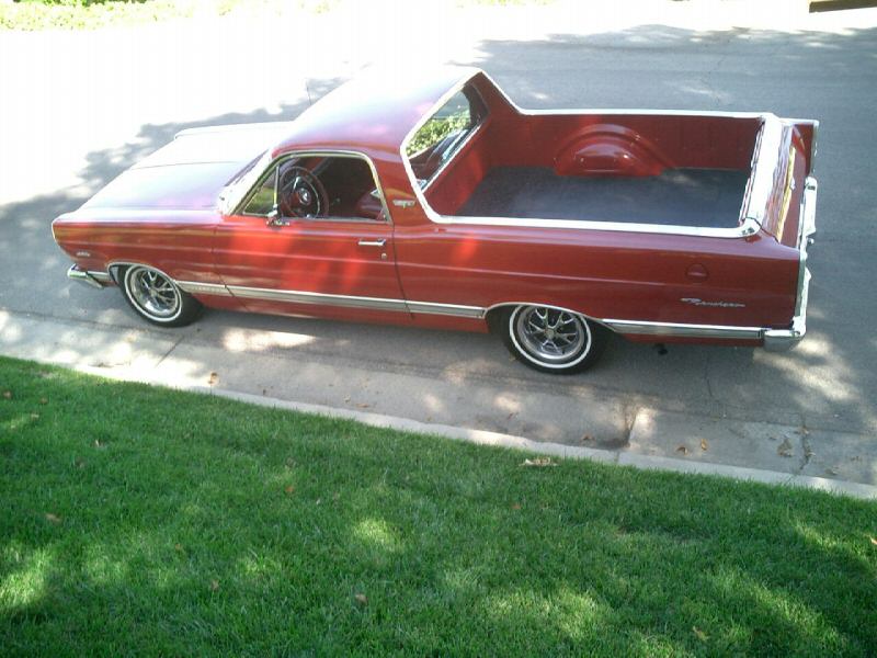 Red Ford Ranchero car-pickup, passenger side, parked on driveway by lawn