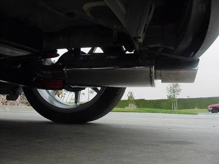 1993 Ford Taurus - Underside view shows the exhaust system and a rear wheel of a car.