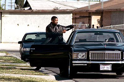 1995 Ford Taurus - A man emerges from a black sedan, holding a handgun, with another vehicle visible behind.