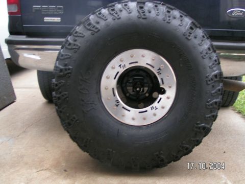 1978 Ford Bronco - A spare tire is mounted on the rear of a black Ford F-250 Super Duty truck.