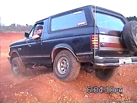 1988 Ford Bronco - This Ford Bronco is kicking up dust as it drives off-road. The timestamp indicates it was taken at 6:04 PM.