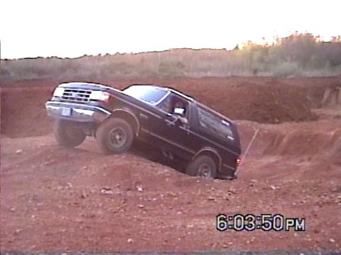 1988 Ford Bronco - This 1988 Ford Bronco is shown tackling an off-road course with one wheel in a ditch.