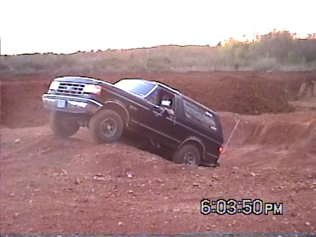 Black 1988 Ford Bronco navigating rough terrain