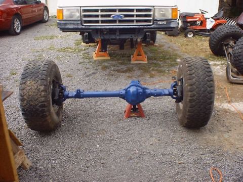 1988 Ford Bronco - Front axle assembly for a 1988 Ford Bronco, a blue differential and large tires.