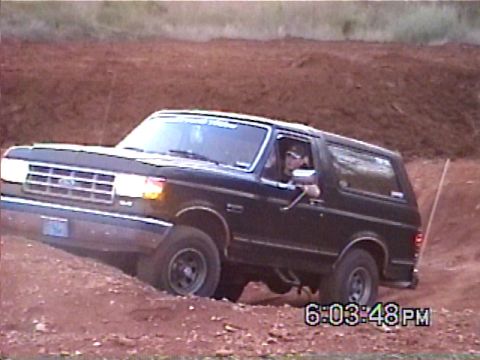 1988 Ford Bronco - This 1987 Ford Bronco navigates a challenging off-road terrain with a driver at the wheel.