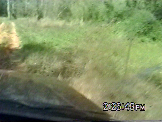 Interior view of vehicle driving on grassy path, timestamp 2:26:43 PM