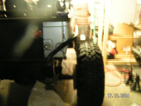 1978 Ford Bronco - The rear corner of a vehicle is visible, a spare tire and a red taillight. A date stamp indicates the photo was taken on October 17, 2004.