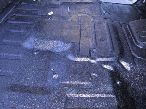 1993 Ford Bronco - The textured floor of a vehicle interior, possibly after a protective coating application.