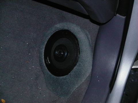 1999 Ford Taurus - A speaker is visible in the carpeted floor of a vehicle's interior.